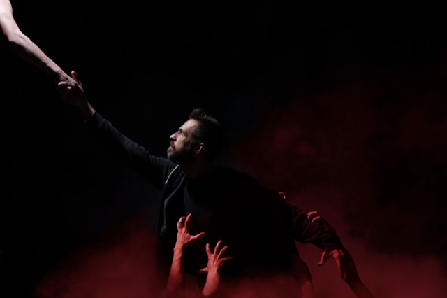 Cinematic lighting and stylized grading by Back to Dust Studios: Man in red fog reaching for light.